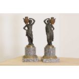 A pair of bronze figural candlesticks,