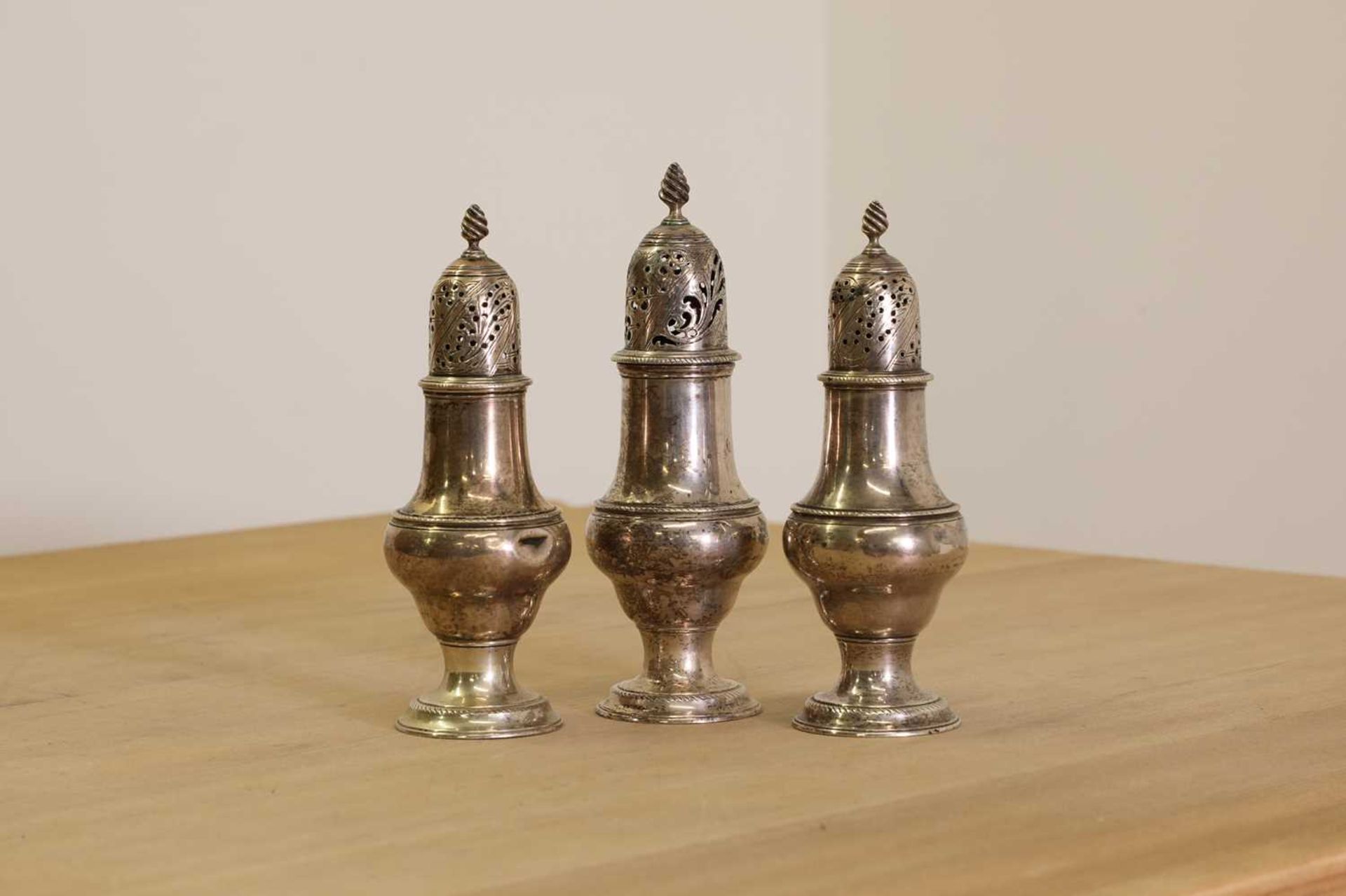 A set of three George III silver condiment casters, - Image 2 of 3