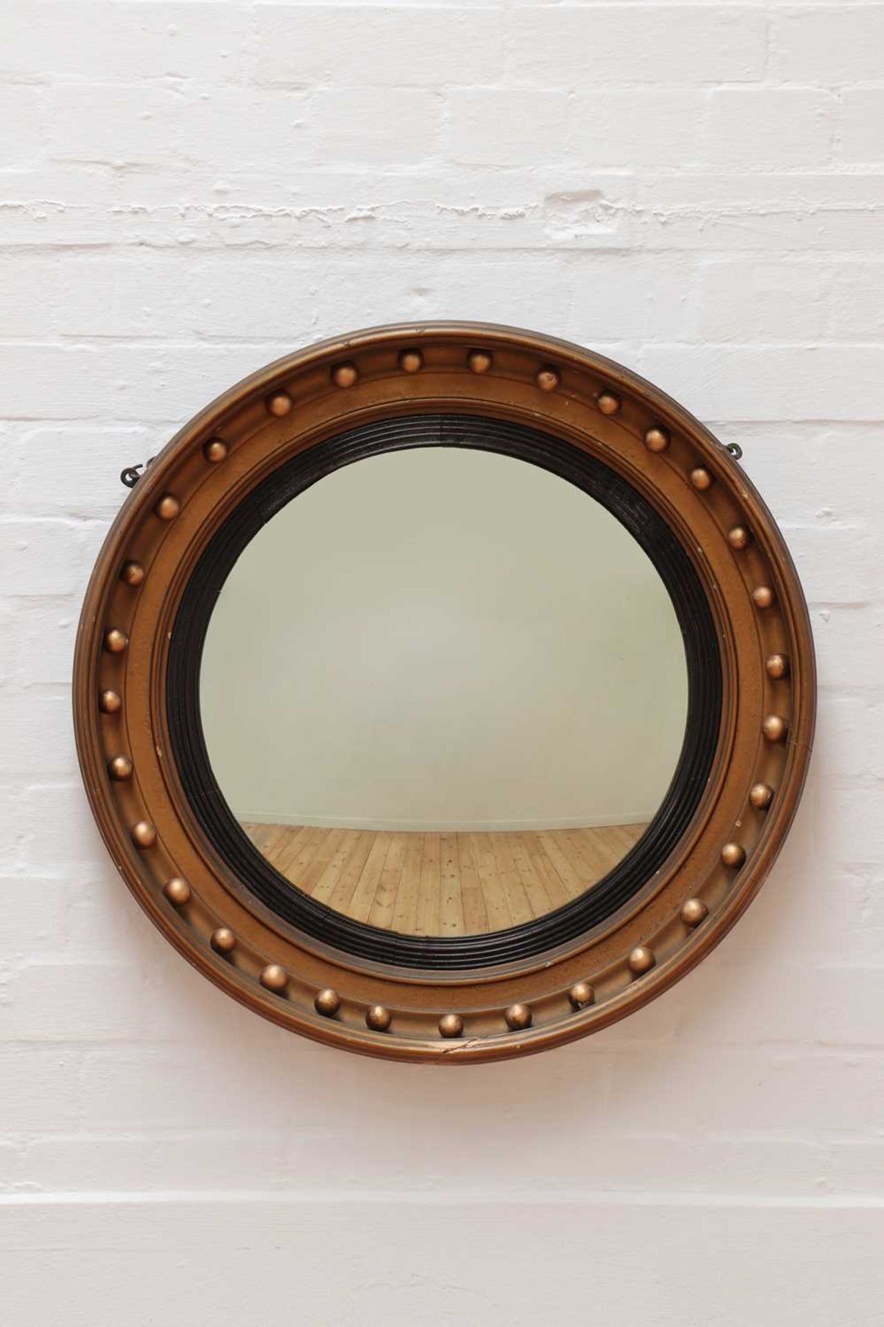 A Regency-style giltwood convex mirror,
