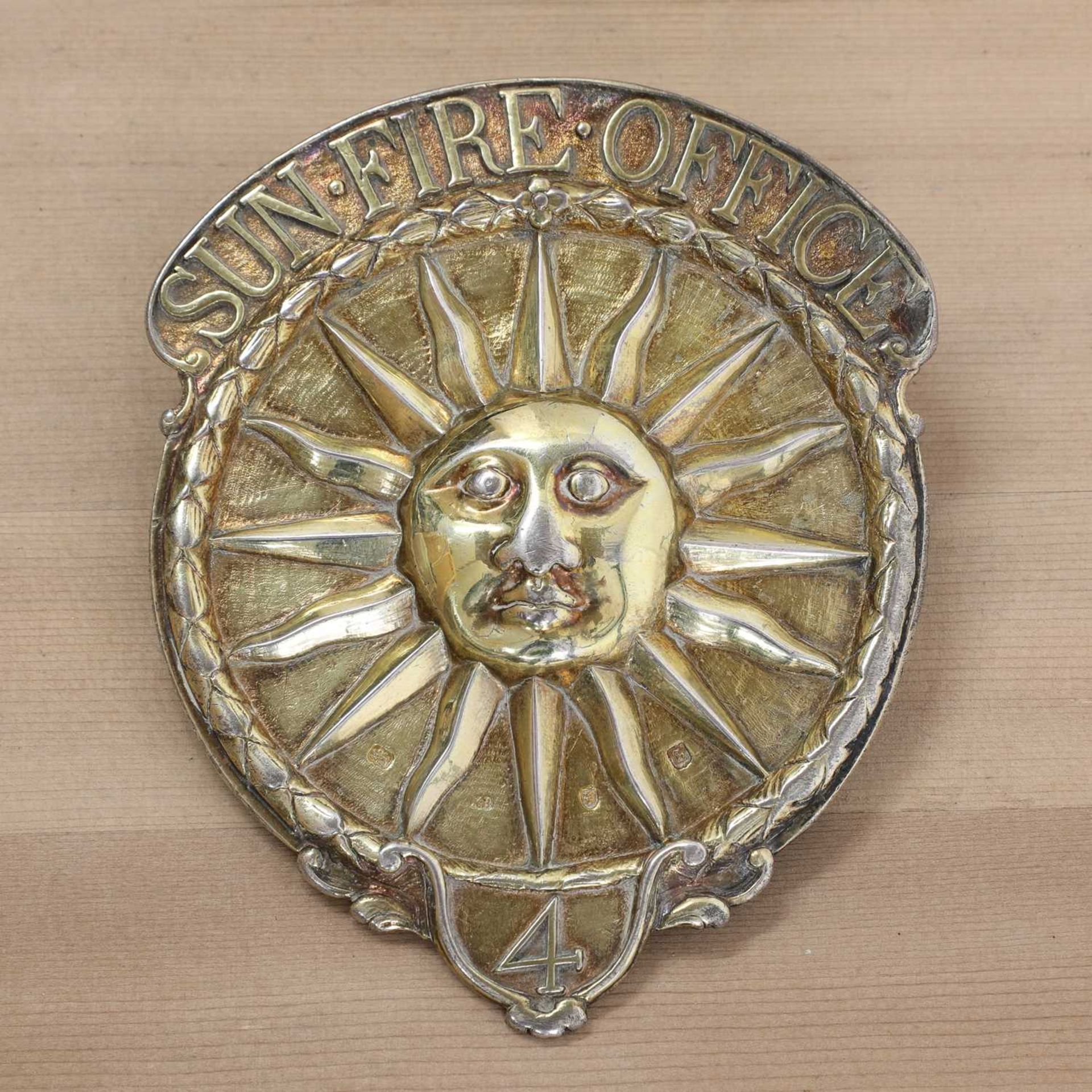 A George III silver gilt Sun Fire Office fireman's arm badge,