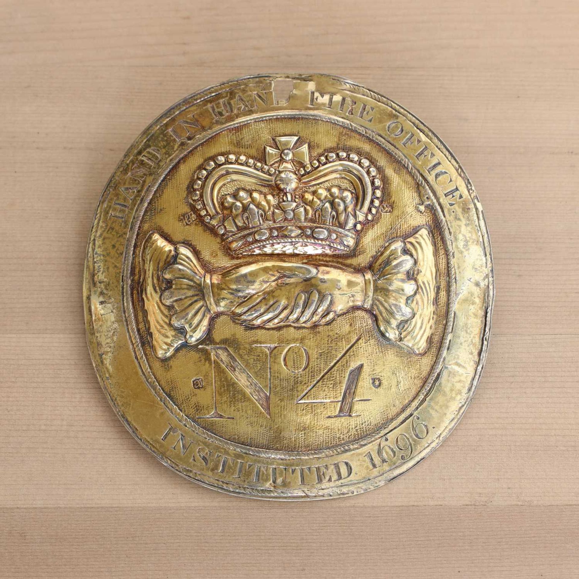 A silver-gilt fire office fireman's badge,