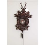 A large carved Black Forest wall-hanging cuckoo clock,
