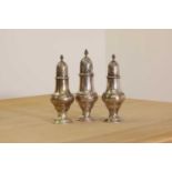 A set of three George III silver condiment casters,