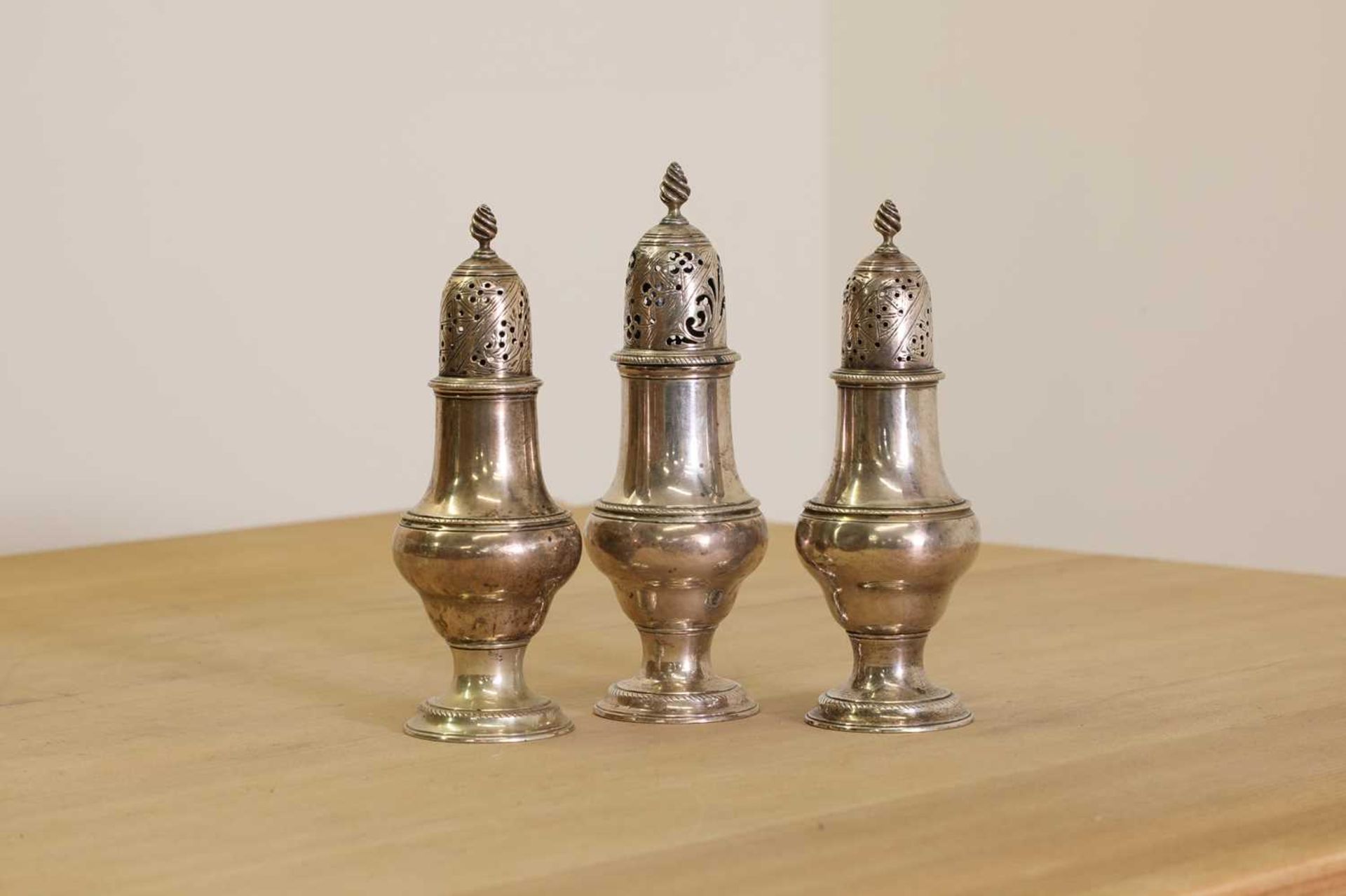 A set of three George III silver condiment casters,