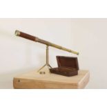 A cased table telescope and folding stand,