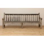A large weathered teak country house bench,
