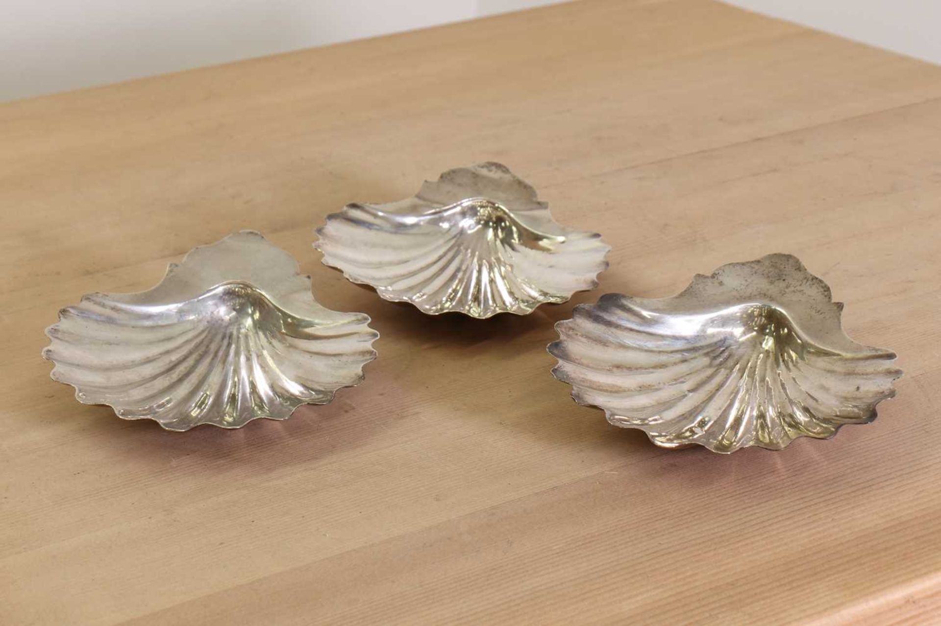 A set of three George III silver butter dishes,