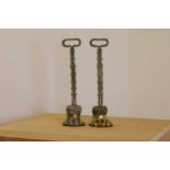 A pair of cast brass door porters,