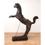 A South-East Asian carved and polychrome painted wooden horse,