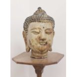 A cast and painted metal head of Buddha,
