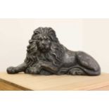 A large cast iron recumbent lion,
