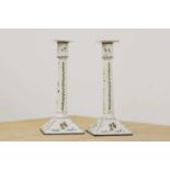 A pair of enamel candlesticks,