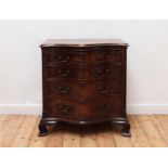 A George III serpentine mahogany chest of drawers,