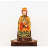 A Chinese polychrome painted wooden house god or attendant,