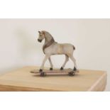 A folk art pull-along horse,