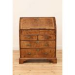 A George II feather strung and crossbanded walnut bureau,