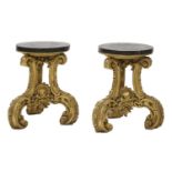 A pair of ornately carved giltwood stands,