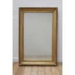 A carved giltwood rectangular mirror,