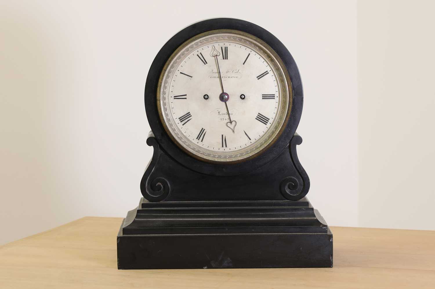 A black marble drumhead mantel clock,