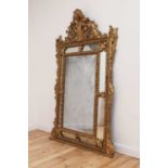 A large Dutch-style gilt-framed wall mirror,