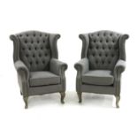 A pair of Queen Anne style wingback chairs,