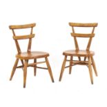 A pair of Ercol white dot child's chairs,