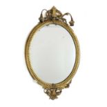 An Edwardian Neo-Classical style oval giltwood wall mirror,