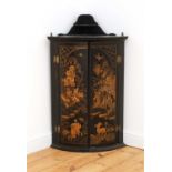 A George III black lacquered bow fronted hanging corner cabinet,