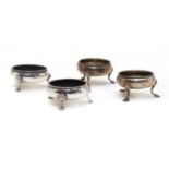 Two pairs of George III silver cauldron salt cellars,