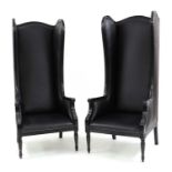 A pair of contemporary high backed wing chairs,