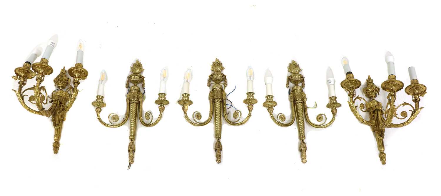 A pair of gilt-bronze three-branch wall lights,