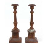 A pair of cast iron candlesticks,