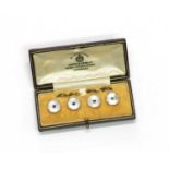 A cased set of four gold sapphire and mother-of-pearl buttons,