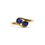 A gold two stone doublet crossover ring,