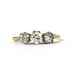 A gold three stone diamond ring,