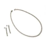 A silver diamond set necklace and earrings suite,