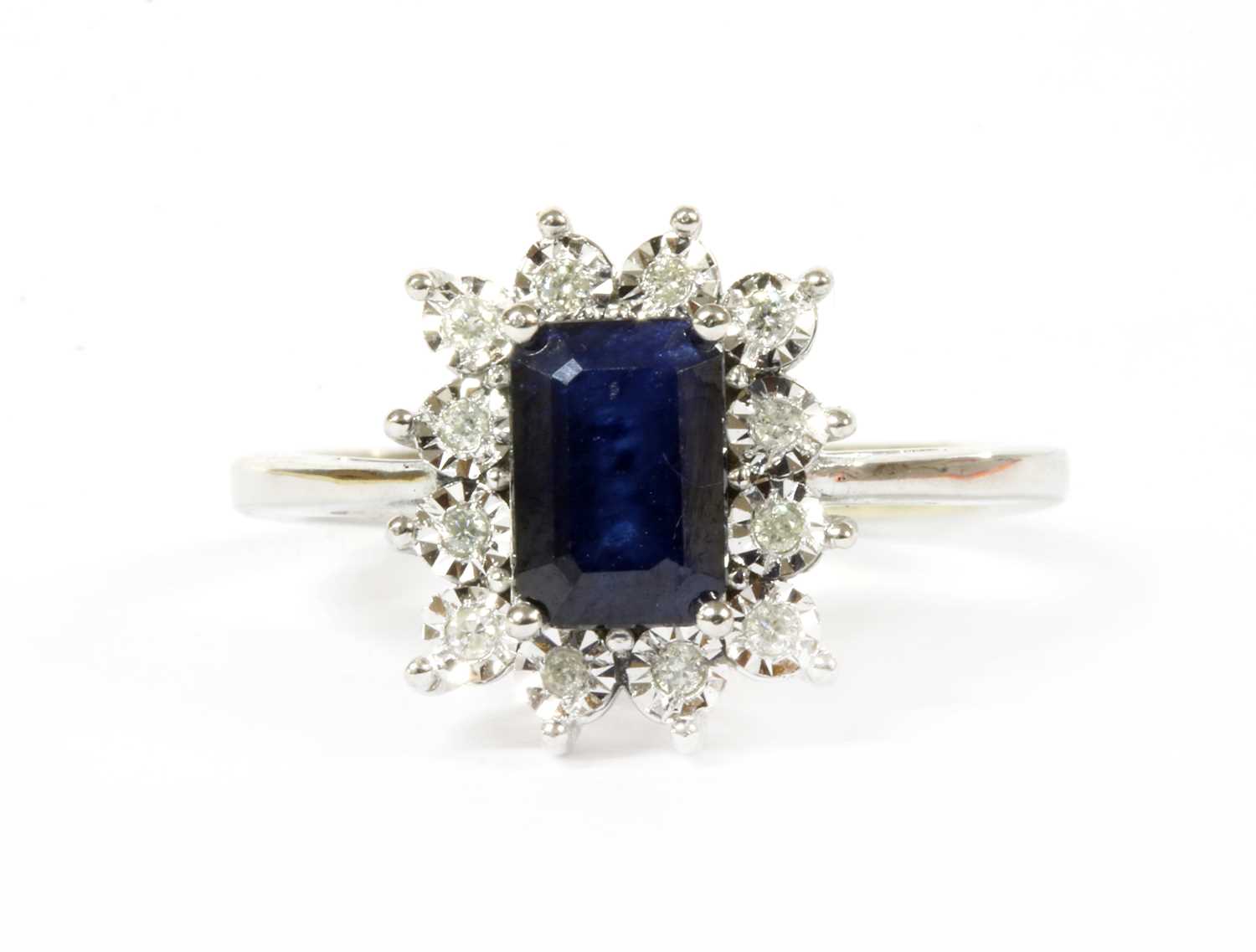 A white gold sapphire and diamond cluster ring,