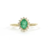 A gold emerald and diamond cluster ring,