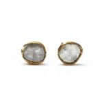 A pair of gold foil-backed diamond stud earrings,