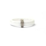 A white ceramic diamond set ring,