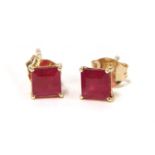 A pair of gold single stone fracture filled ruby stud earrings,