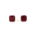 A pair of gold single stone fracture filled ruby stud earrings,