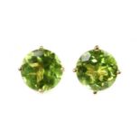 A pair of single stone peridot stud earrings,