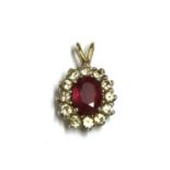 A gold ruby and diamond cluster pendant,