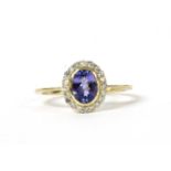 A gold tanzanite and diamond cluster ring,