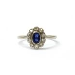 A white gold sapphire and diamond cluster ring,