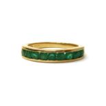 An 18ct gold emerald half eternity ring,