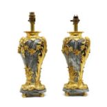 A pair of grey marble and ormolu table lamps of vase form,