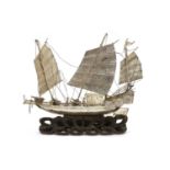 A Chinese export white metal model of a junk,