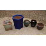 A group of five garden pots,